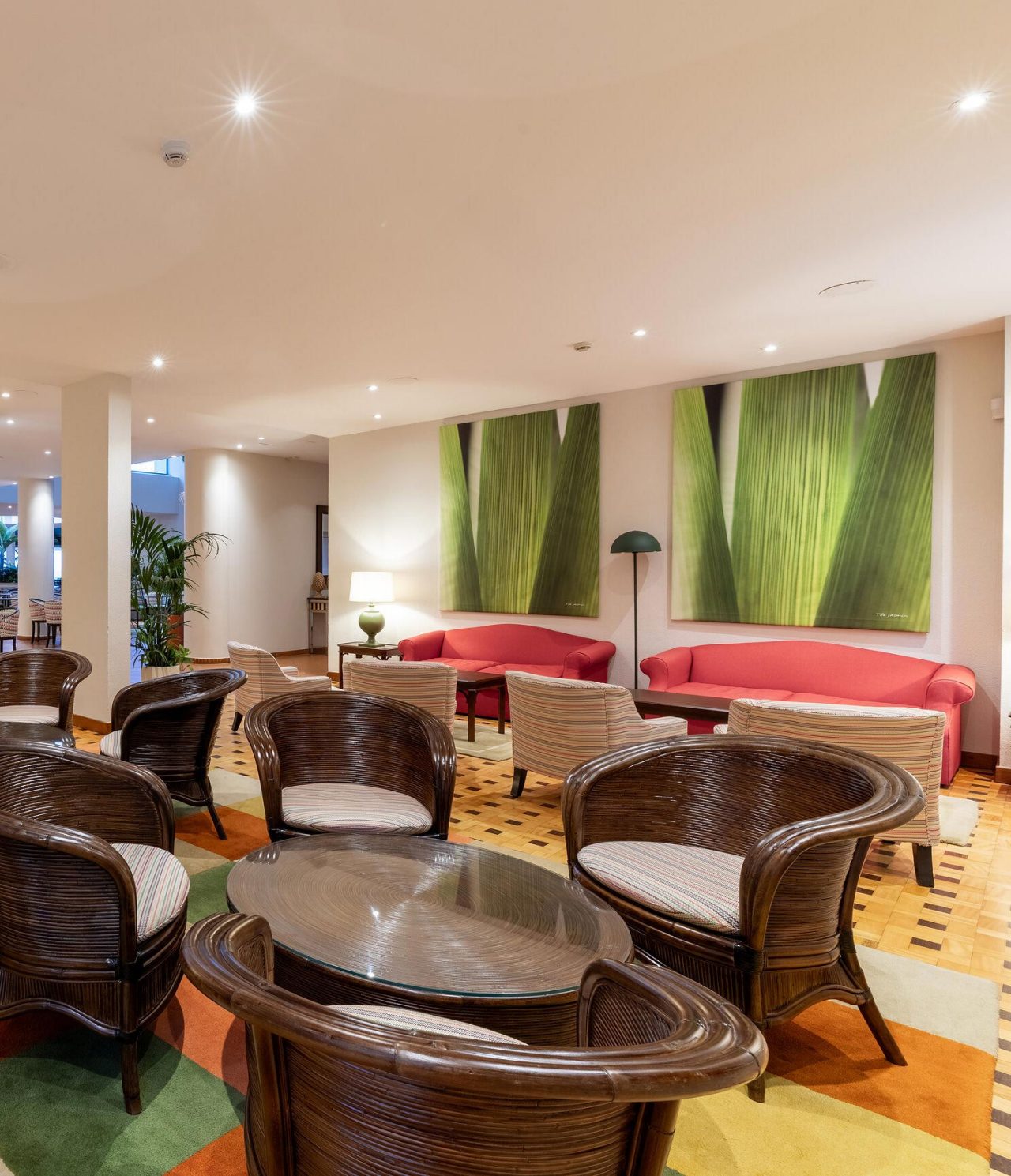 The Arlequim bar at the 5-star hotel in Funchal, Madeira has chairs with round tables and checkered carpet