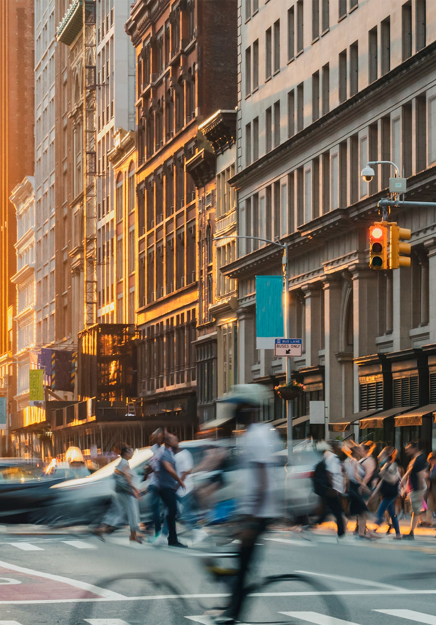 View of Fifth Avenue in Manhattan New York with skyscrapers and cars and people moving